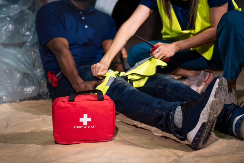 man receiving first aid after being injured at work